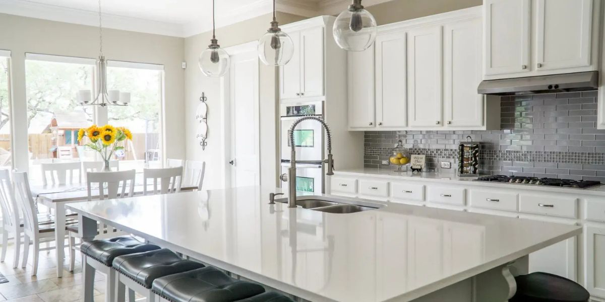 Homeowner comparing kitchen countertop materials, colors, and finishes with a remodeling professional to choose the right option | How to Choose a Countertop for Your Kitchen Remodel